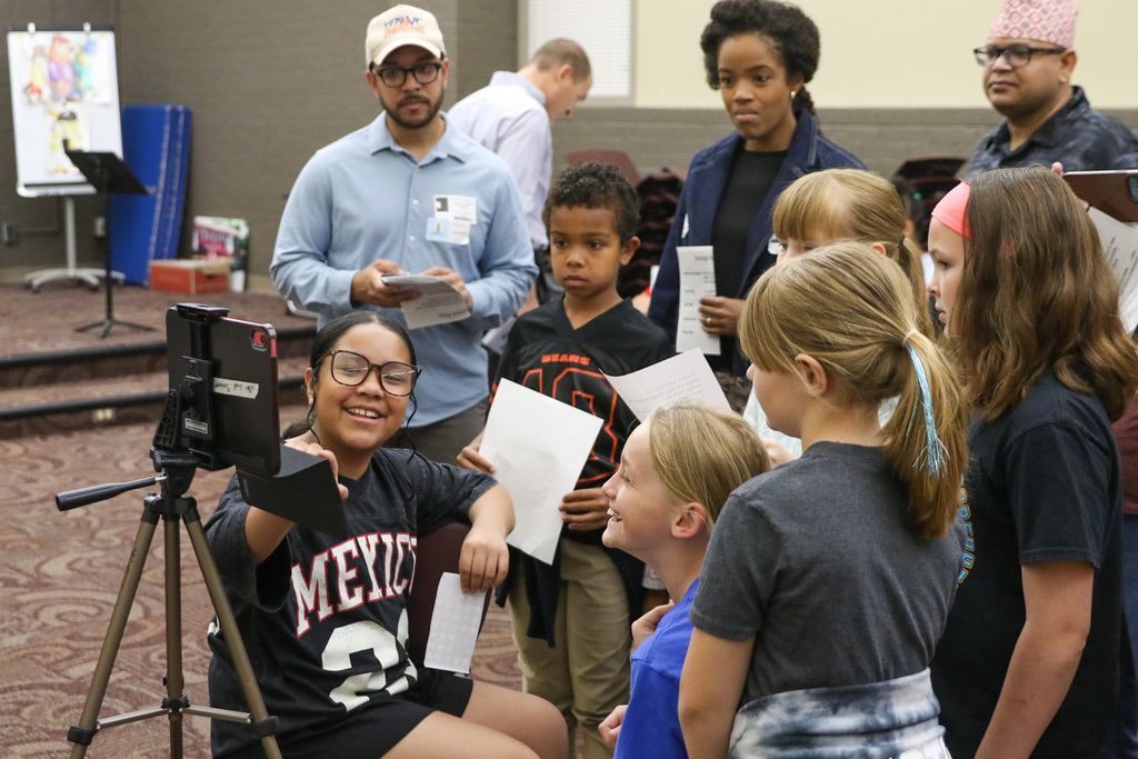 girl showing peers and adults how to do stop motion