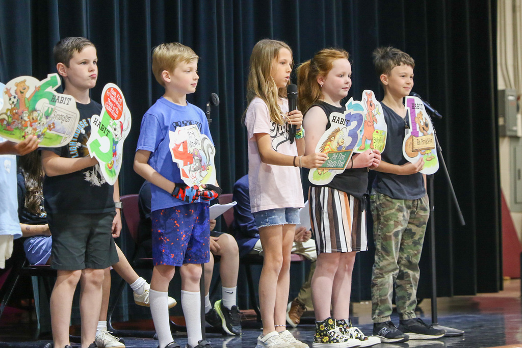 students on stage talking about the 8 habits