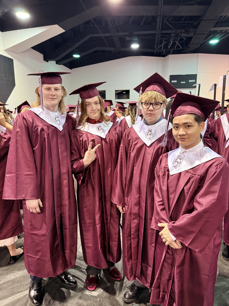 four male students in their graduation gowns