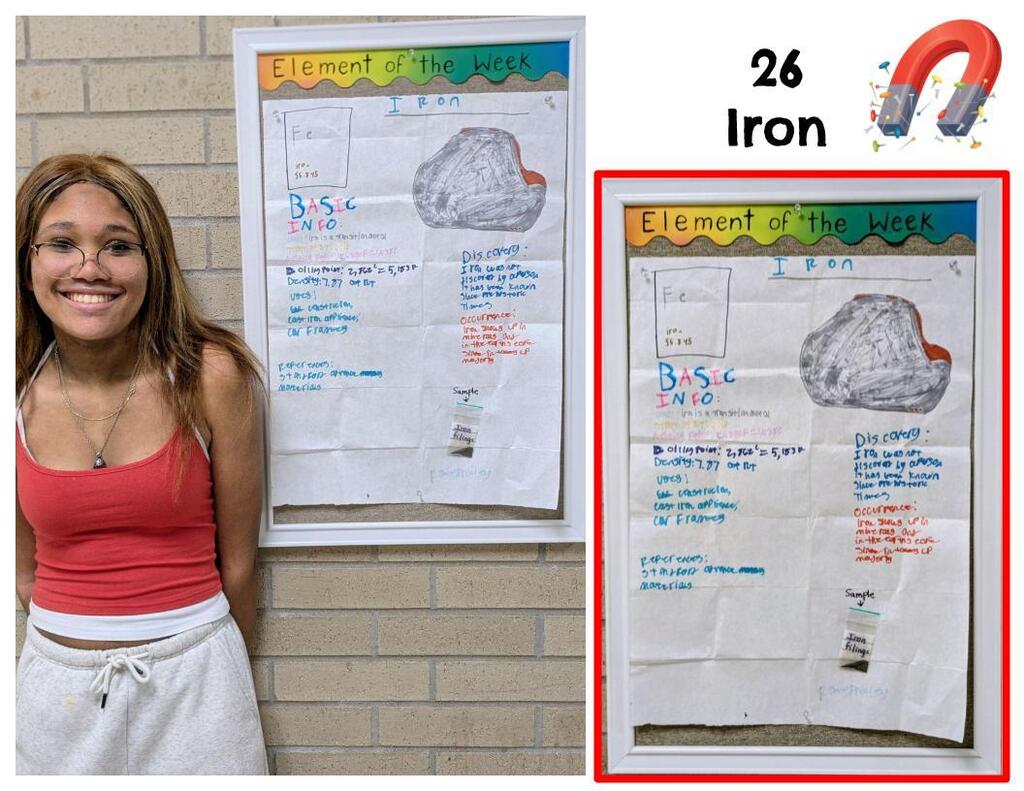 Student standing next to element poster