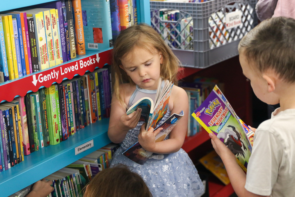 little girl flipping through the pages of a book