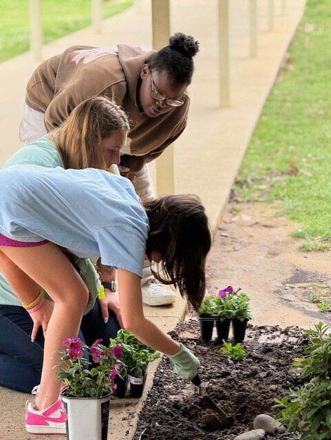 Peers with Purpose students planting flowers