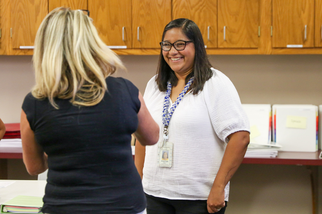 woman standing and smiling at the woman across from her
