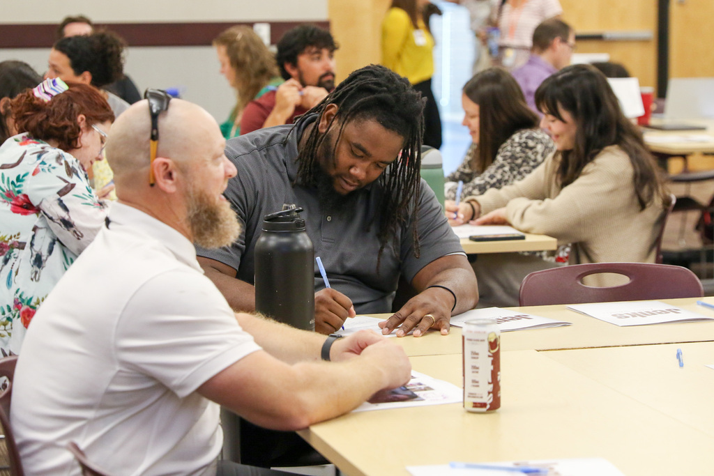 man taking notes at a table