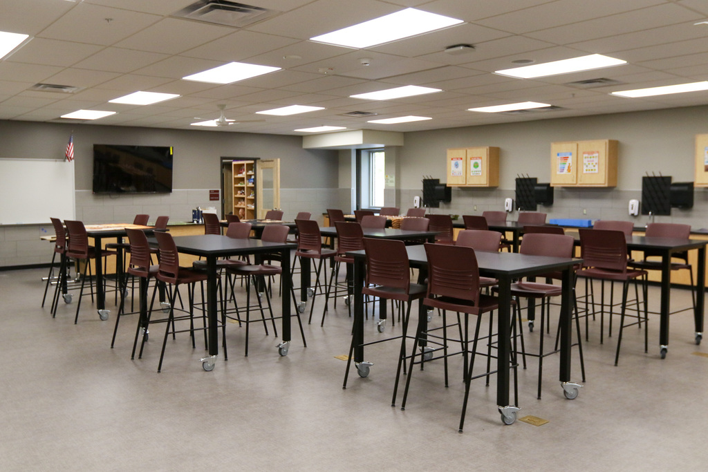 a lab classroom with tall tables and chairs on wheels.