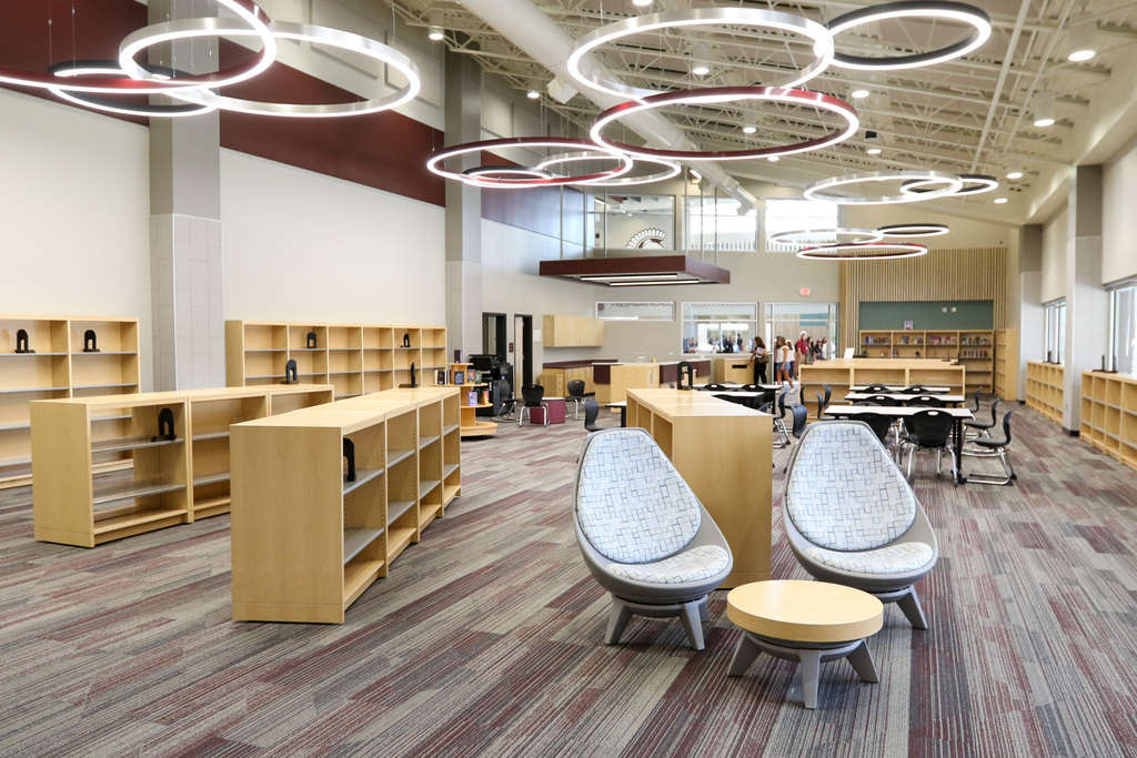 photo of inside the media center. two swivel chairs are in the front of the photo along with empty bookshelves