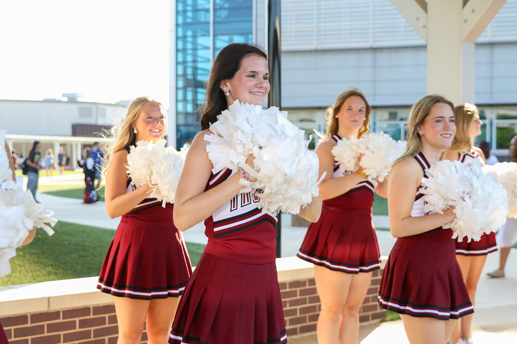 Pom squad outside cheering on students for the first day