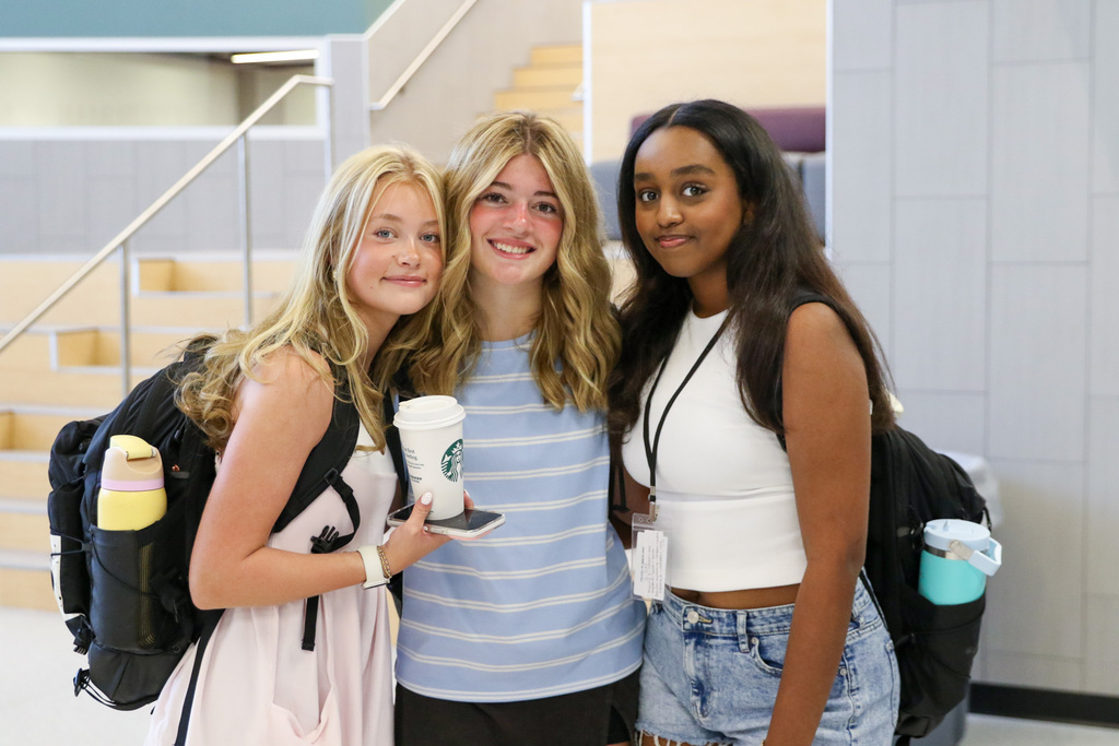 3 freshman girls posing for a photo inside the new freshman academy commons