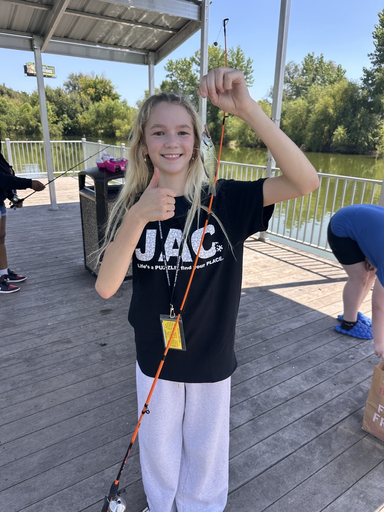 a student showing a Fish they caught