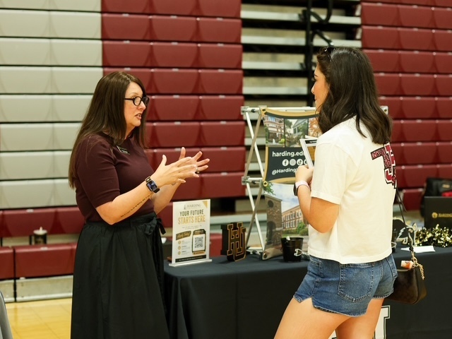 student speaking with a representative from harding university
