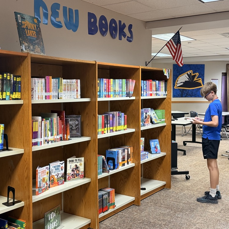 student looking at new books