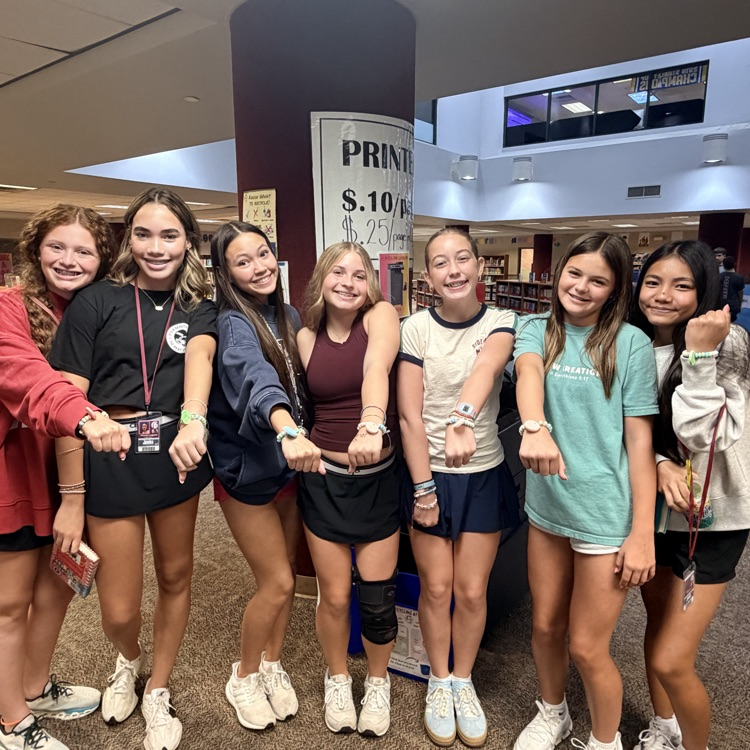 girls showing candy soccer bracelets