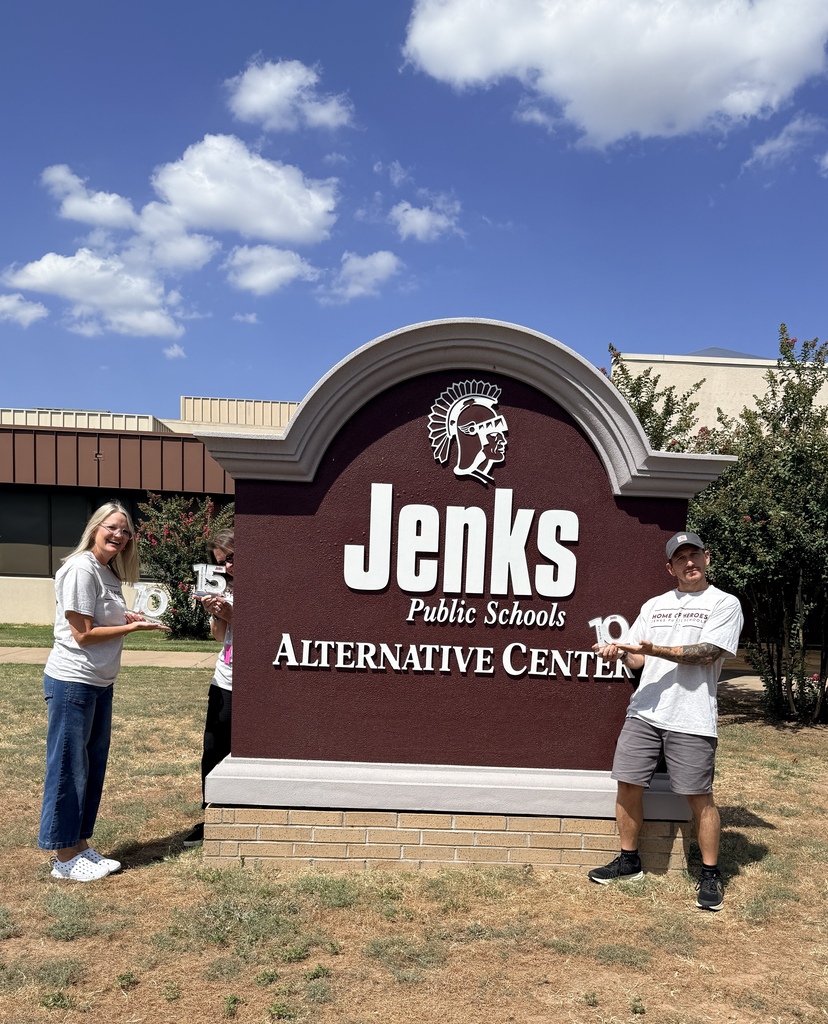JAC sign and staff with years of service awards