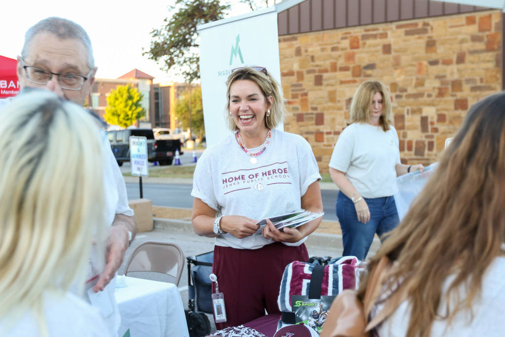 trojan shop manager smiling and laughing with a staff member at her table