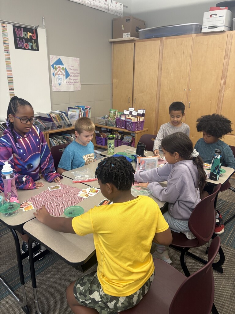 Table group work together to solve card game.