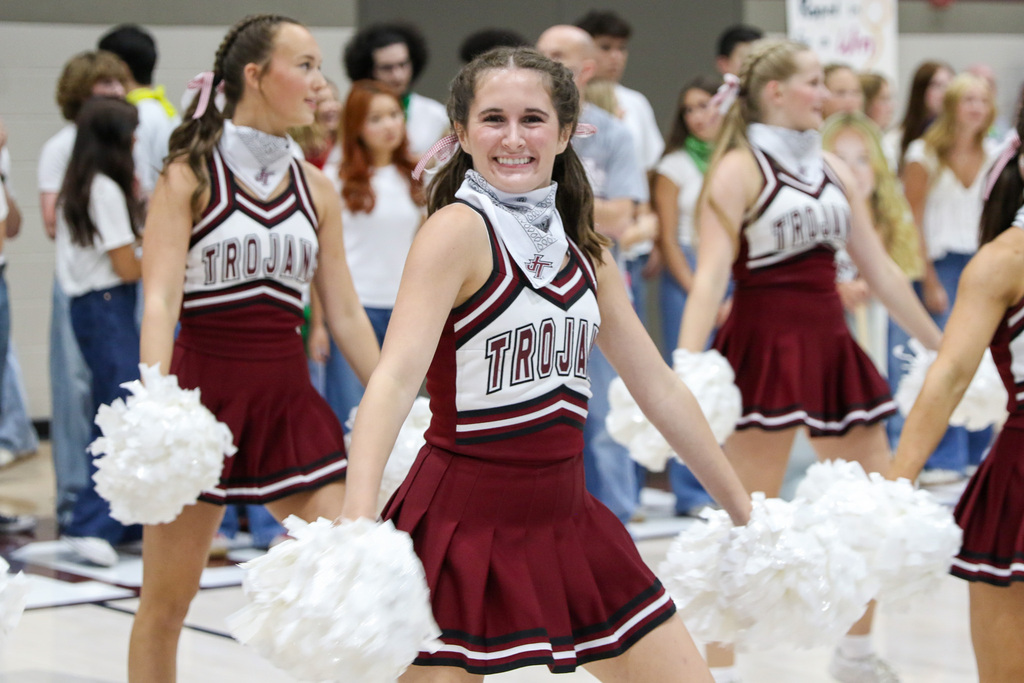 pom girl dancing and smiling directly at the camera