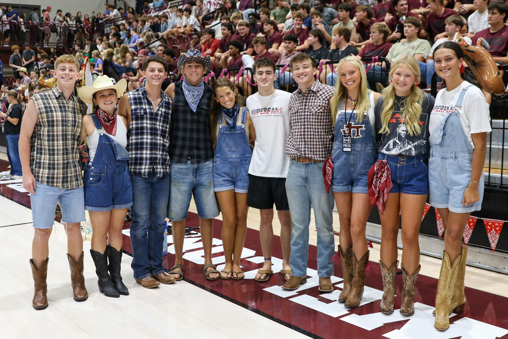 group of student council students dressed in western wear posing together for a big group photo