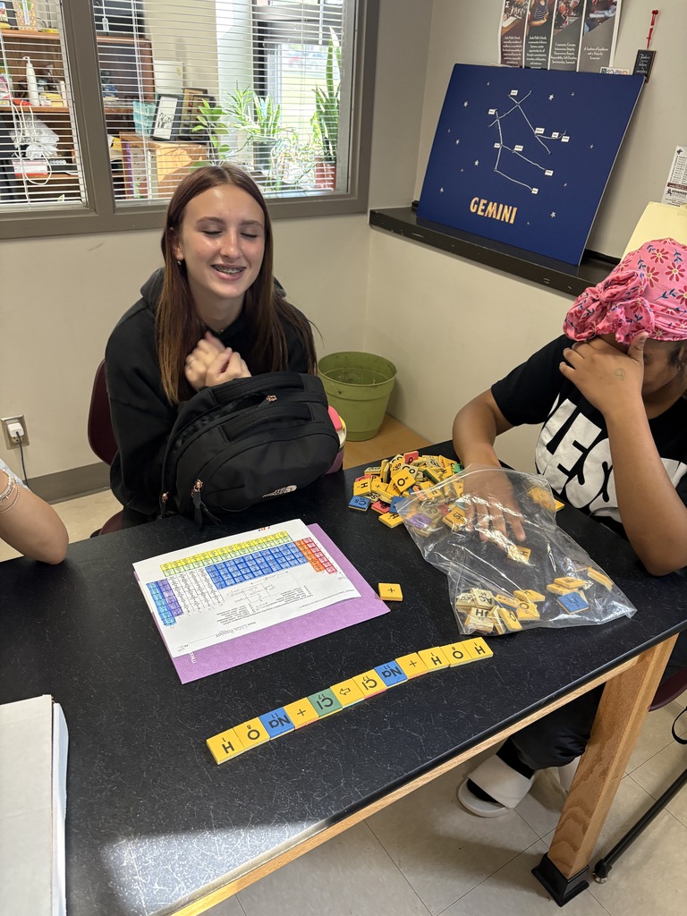 a student with periodic table tiles