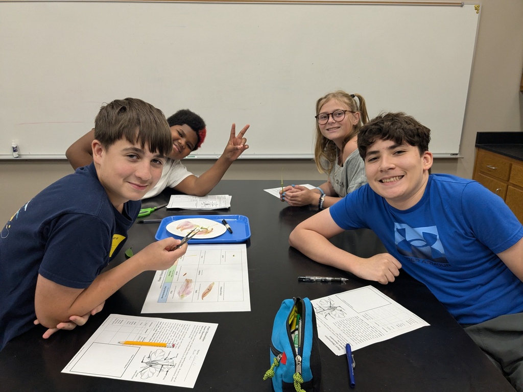 4 students at a science lab table
