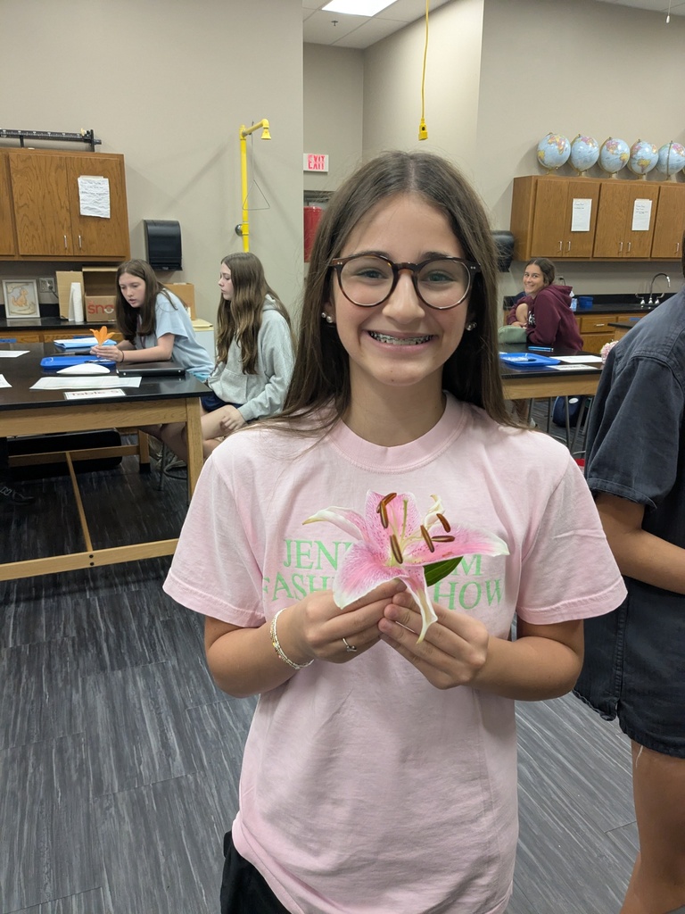 student holding a starburst lily