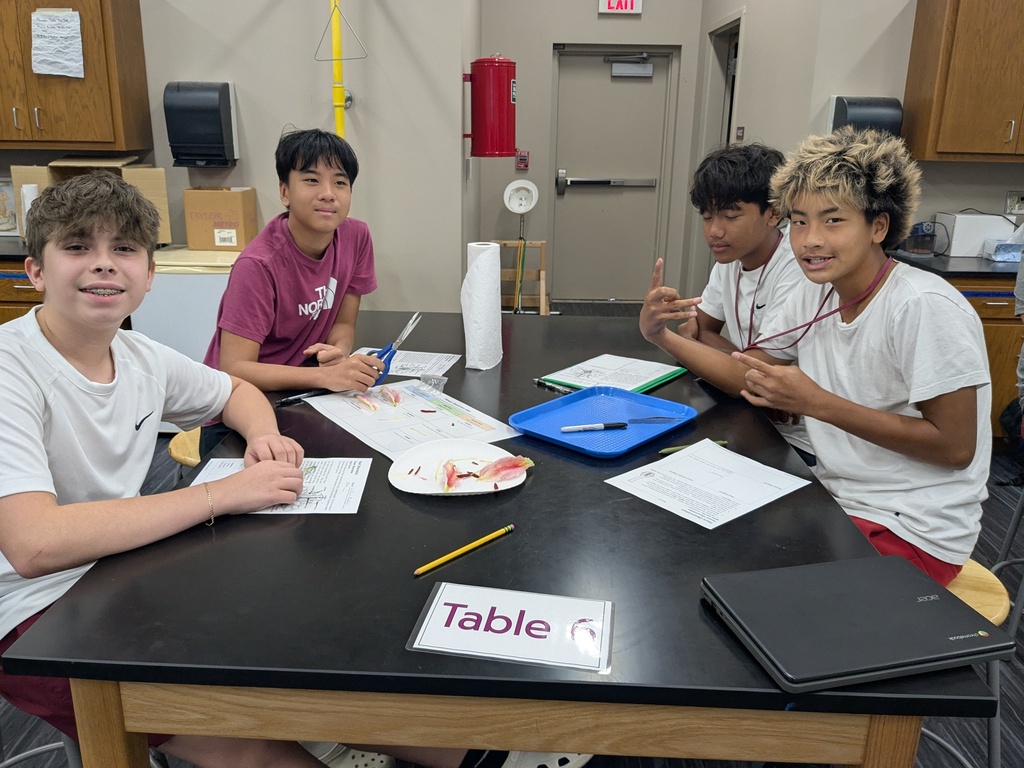 4 students at a science lab table