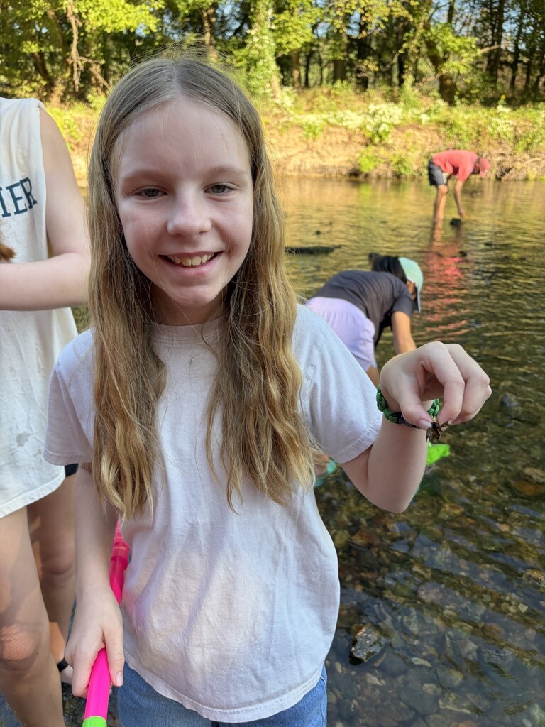 student holding a crawfish