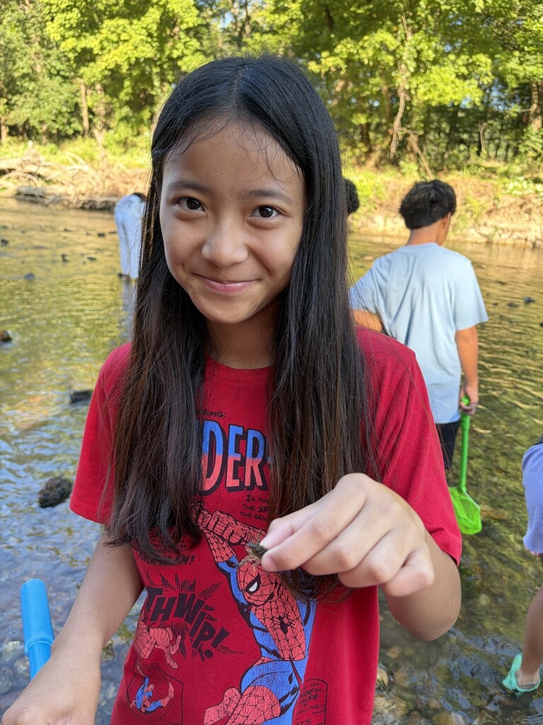 student holding a crawfish