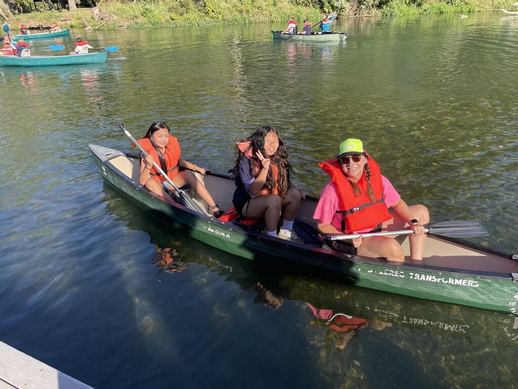 students and counselor inside a canoe at Jenks wild