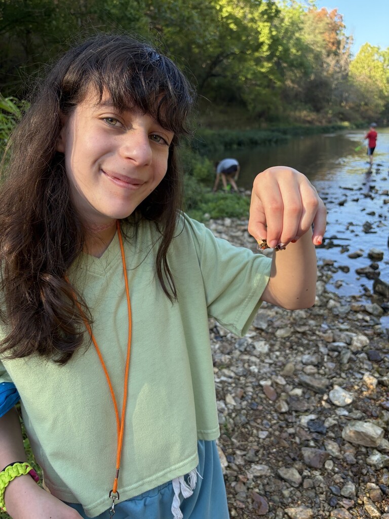 student holding a crawfish