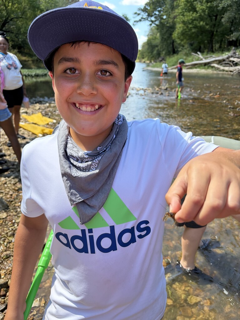 student with crawdad at jenks wild