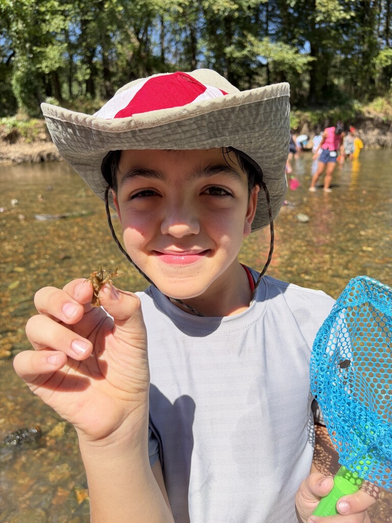 student with crawdad at jenks wild