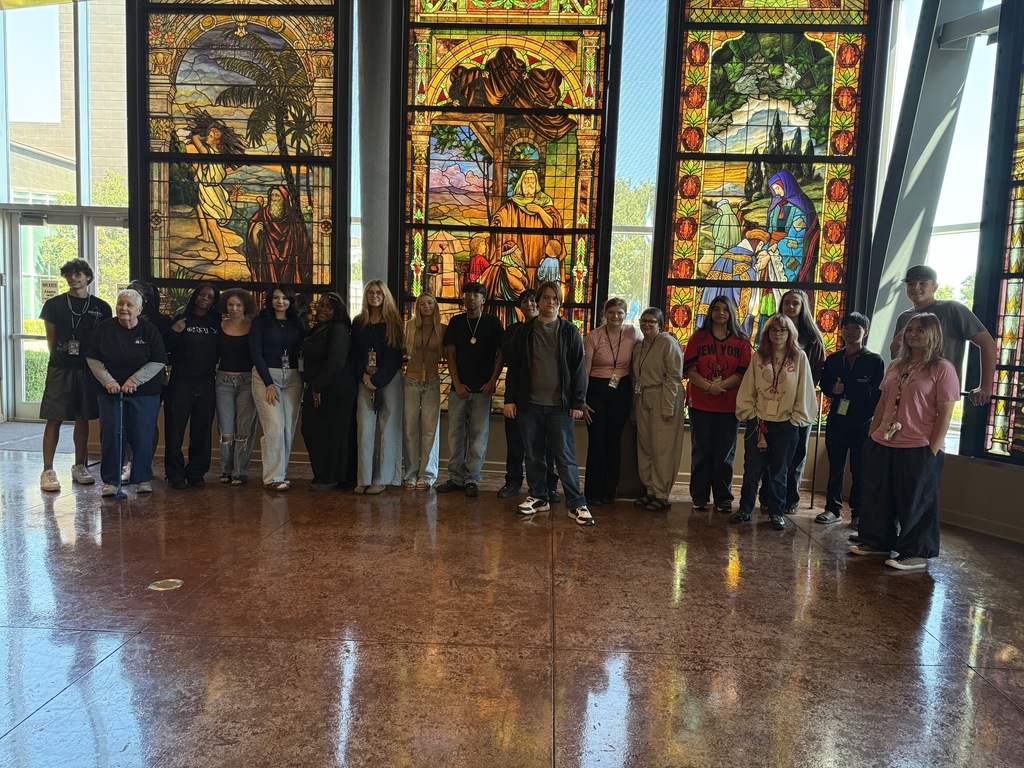 students in front of stained glass windows