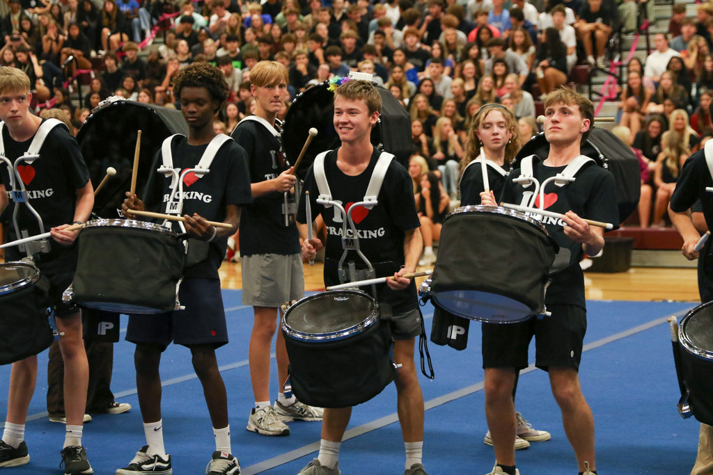 photo of drumline drumming and doing a little dance with their drums