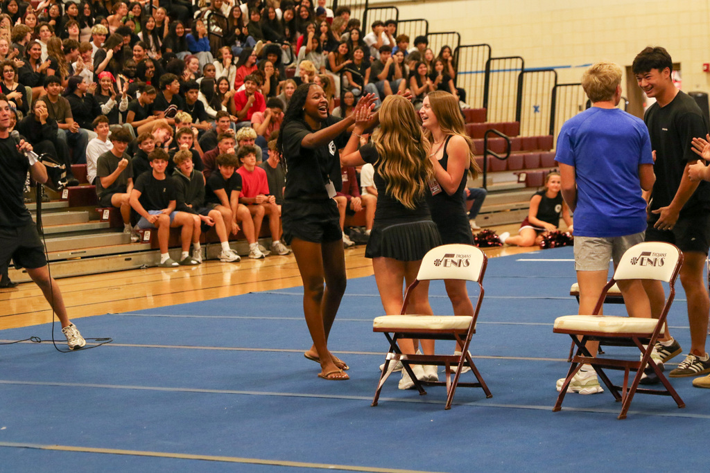 3 girls high fiving after winning a game against boys