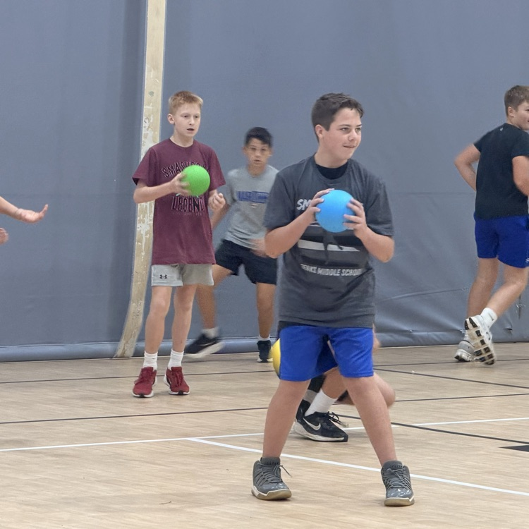 students holding brightly colored dodgeball’s