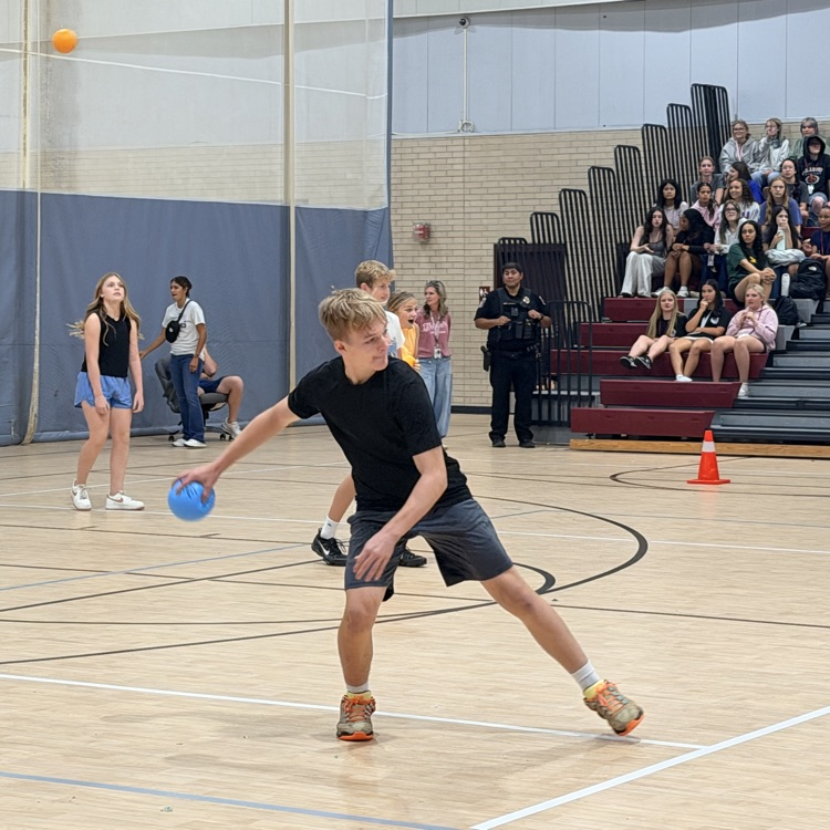 student gearing up to throw a dodgeball