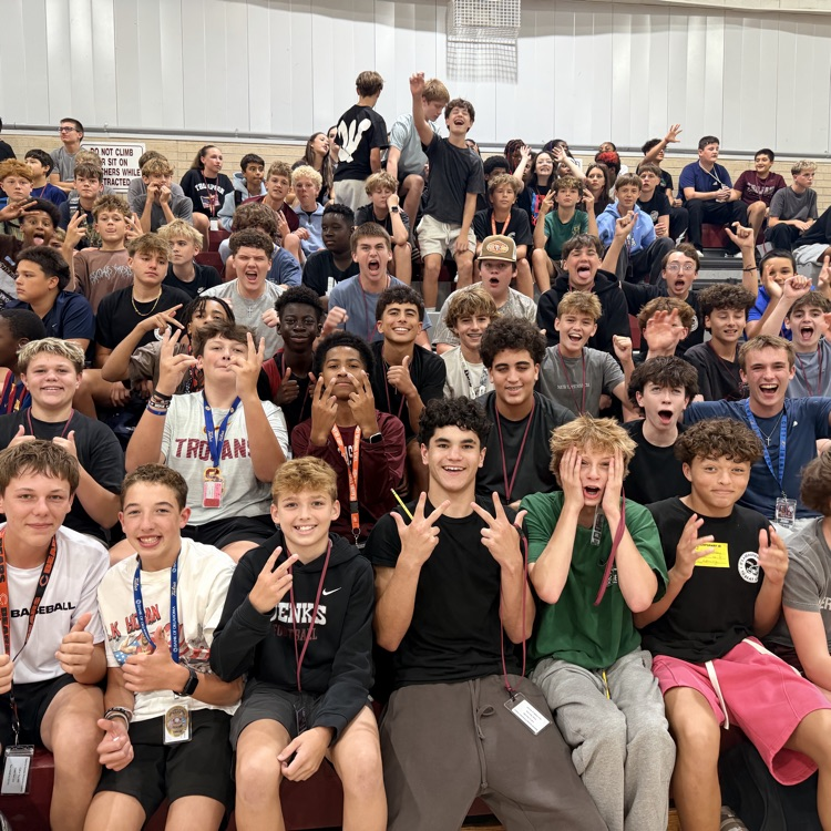 eighth grade students in the fans cheeringm