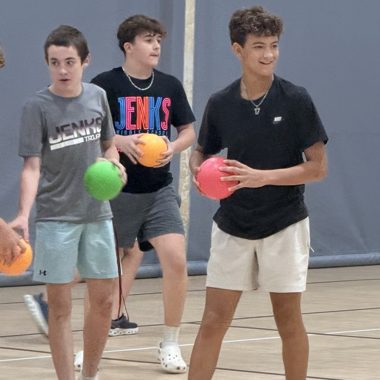 eighth grade students holding dodgeball