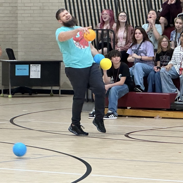 teacher pointing toward students