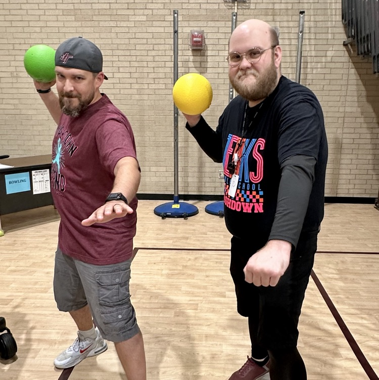 two male teachers holding dodgeball