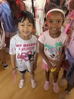 two girl students with glow sticks at dance a thon celebration