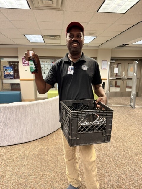 Mr Wayne holding his Scope coffee and milk crate backpack