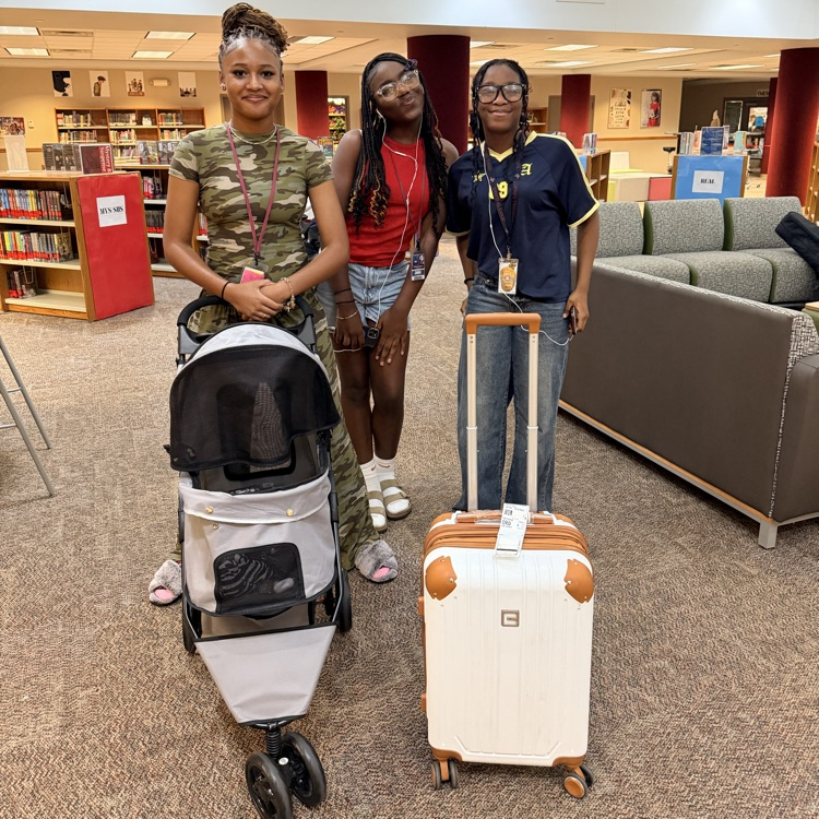 student with a baby stroller and student with a suitcase