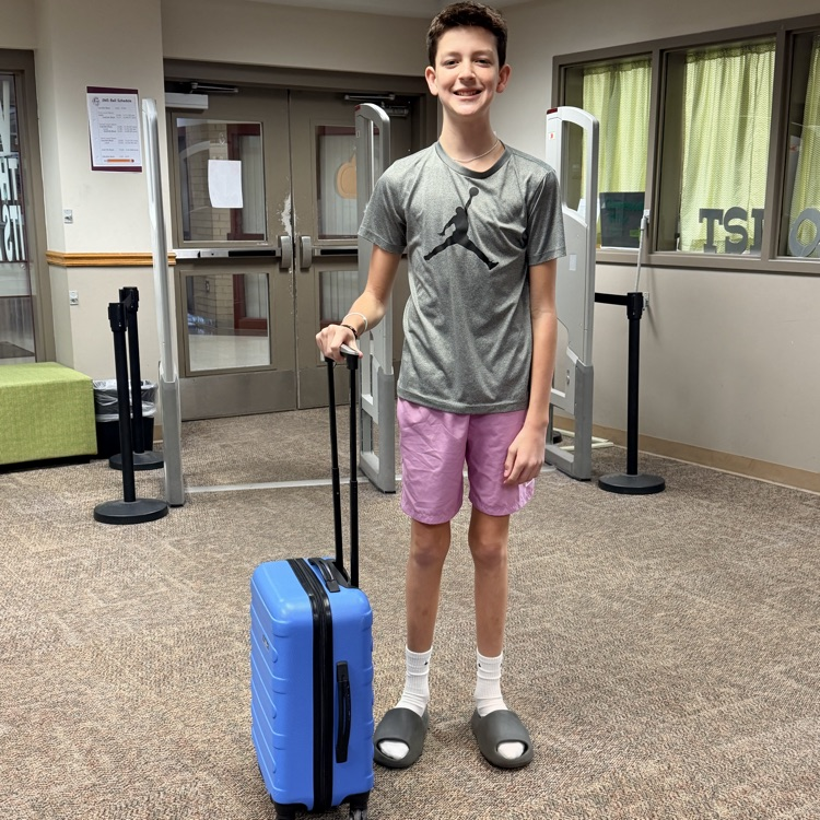 student with a suitcase as a backpack
