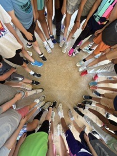 3rd and 4th grade shoes in a circle after first run club practice