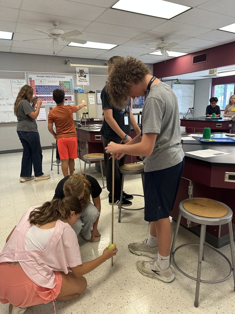 students measuring how high a tennis ball bounced