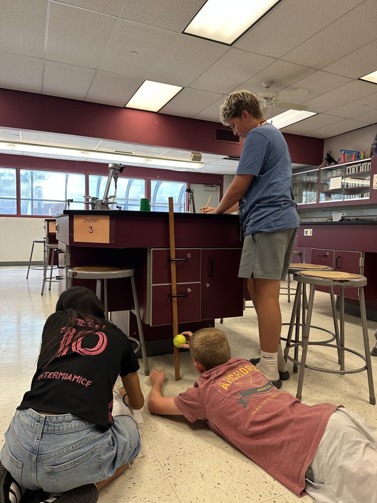 3 students working on tennis ball science lab