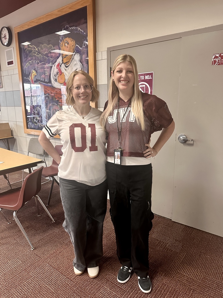 two teachers with jerseys on