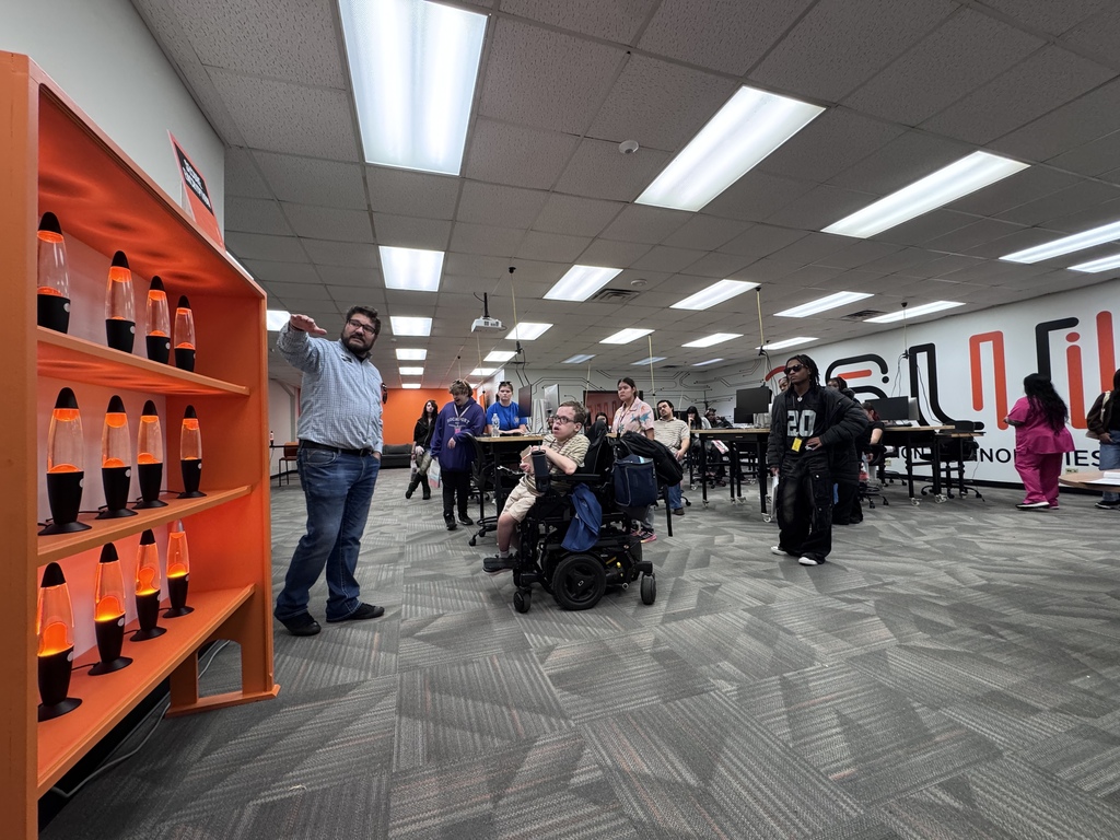 a man explaining a display to students