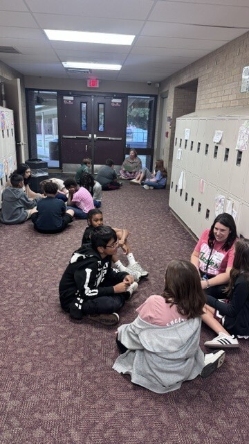 Marvelous moms guests sharing a story with students